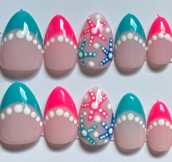 Teal and pink starfish nails with white dots