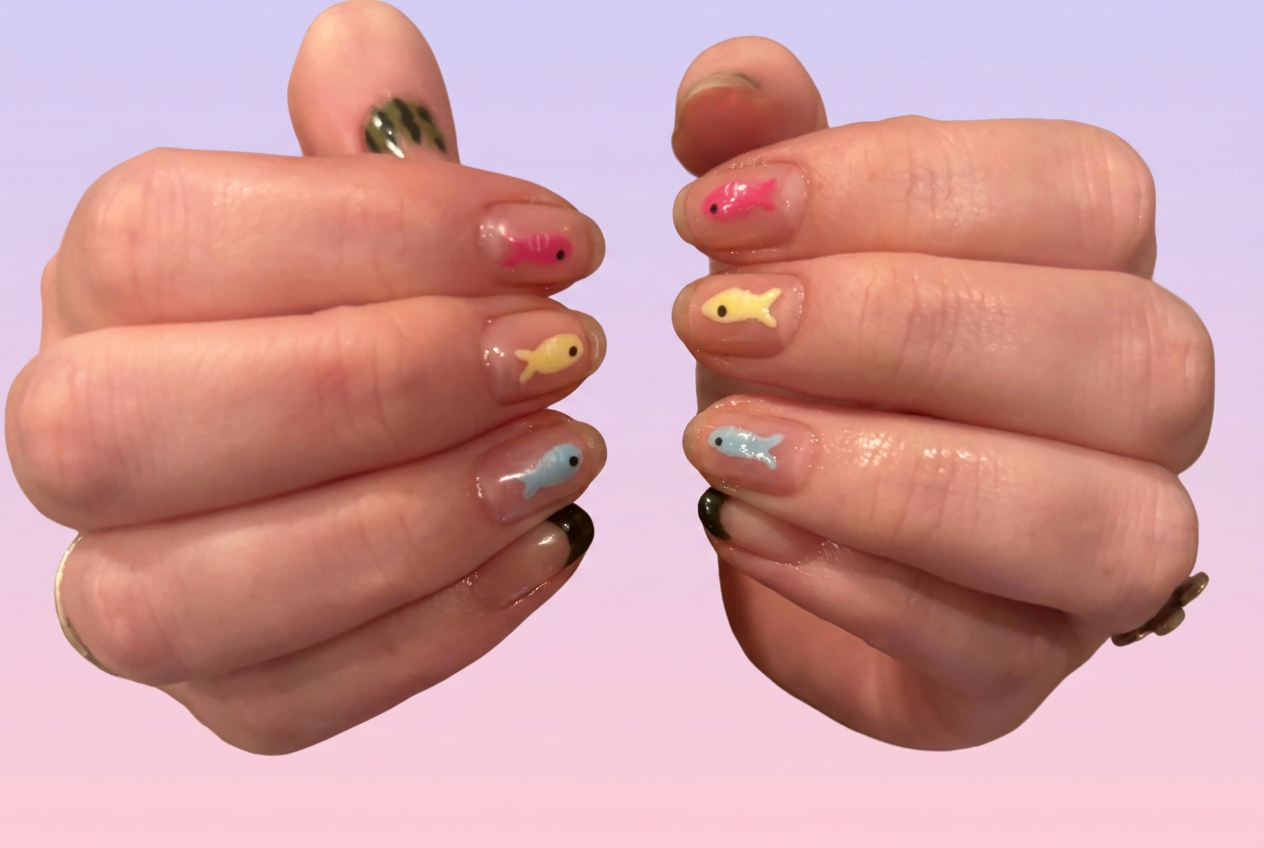 Clear nails with tiny pastel fish charms